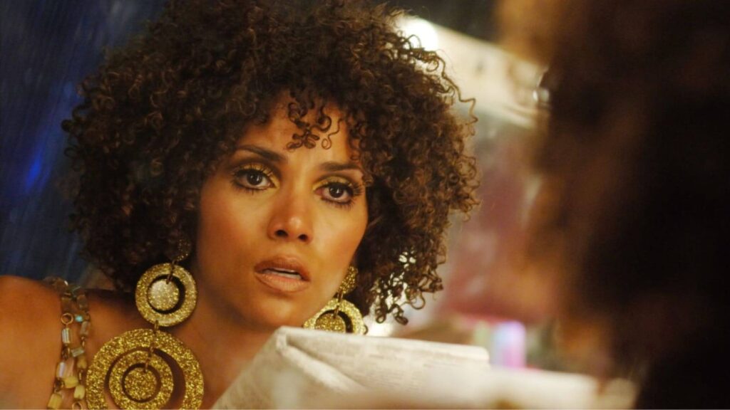Halle Berry wearing large gold earings while reading a script in 'Frankie & Alice,' Halle Berry, Hallelujah! A Retrospective of Her Most Iconic Roles