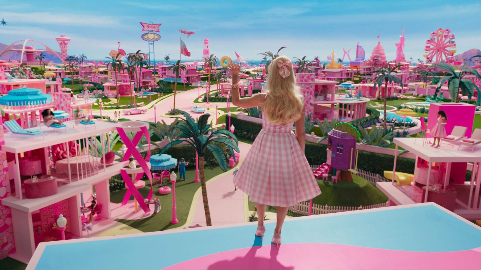 Barbie (Margot Robbie) waving to everyone in Barbie Land in 'Barbie,' Beyond the Plastic: Breaking Down the 'Barbie' Screenplay