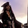 Jack Sparrow (Johnny Depp) standing on top of his ship as it sinks into the sea in 'Pirates of the Caribbean: The Curse of the Black Pearl' (2003)