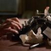 A man typing on a typewriter in 'Barton Fink,' How To Get Started as a Screenwriter