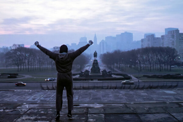 Rocky (Sylvester Stallone) celebrating at the top of a staircase in 'Rocky;' 10 of the Best Films Set in Philadelphia
